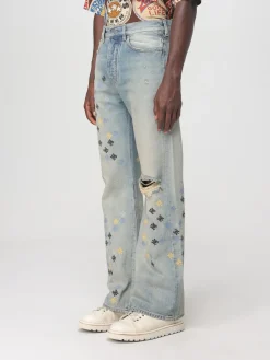 Jeans con logo all-over Amiri