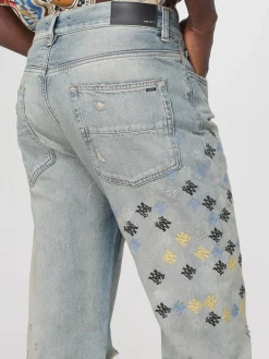 Jeans con logo all-over Amiri