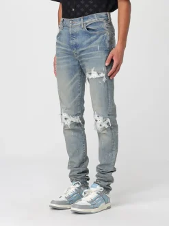 Jeans con rotture e toppe stampate Amiri